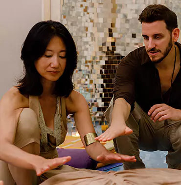 Energy healing practitioner working with a client in a calm, professional setting